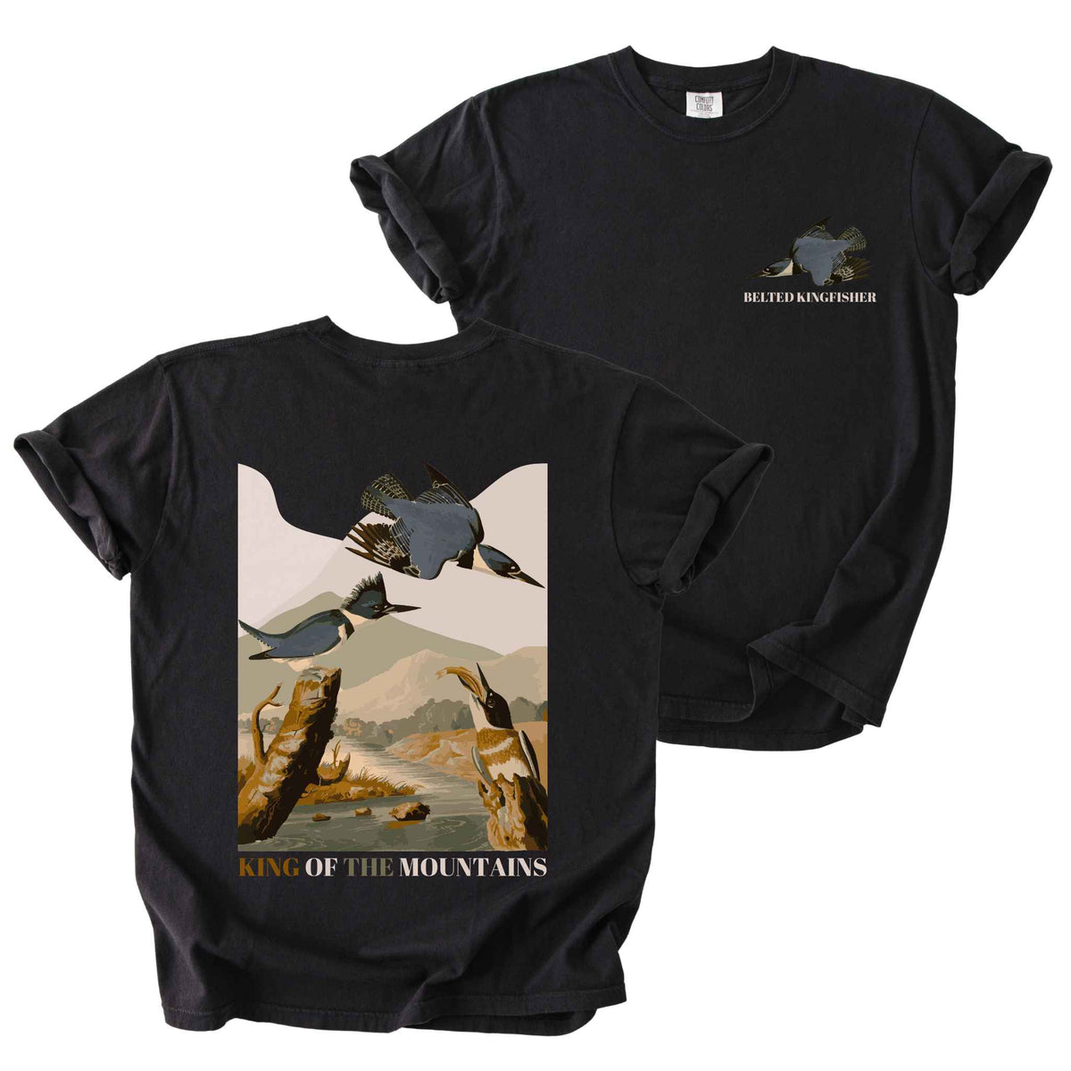 Black "Belted Kingfisher, King of the Mountains" t-shirt on Comfort Colors tee, featuring a small front chest logo and a full illustrated back print of kingfishers over a river landscape in retro poster style. Birdwatcher gift shirt for wildlife and nature enthusiasts.