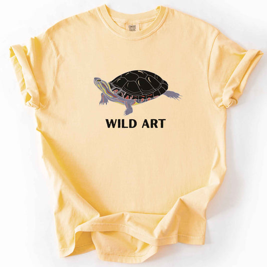 Butter "Wild Art" t-shirt on Comfort Colors tee, featuring a bold graphic of a painted turtle with bold black text below. Reptile lover and turtle enthusiast gift shirt for wildlife and nature fans.