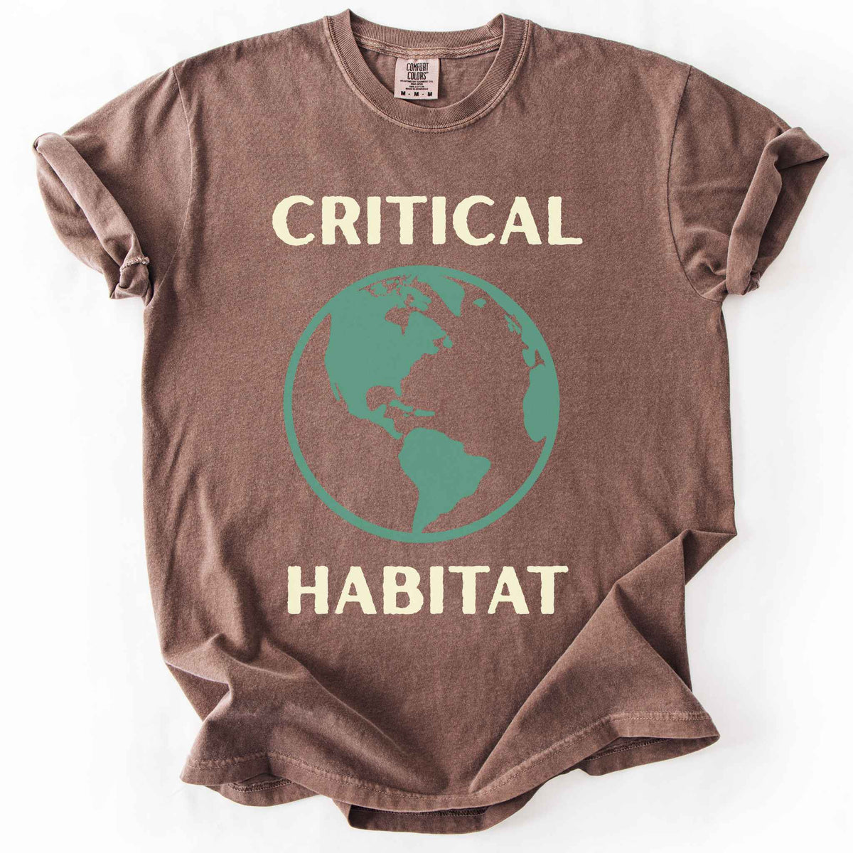 Espresso "Critical Habitat" t-shirt on Comfort Colors tee, featuring a bold green globe graphic with cream lettering. Conservation and environmentalist gift shirt for earth science and wildlife protection advocates.