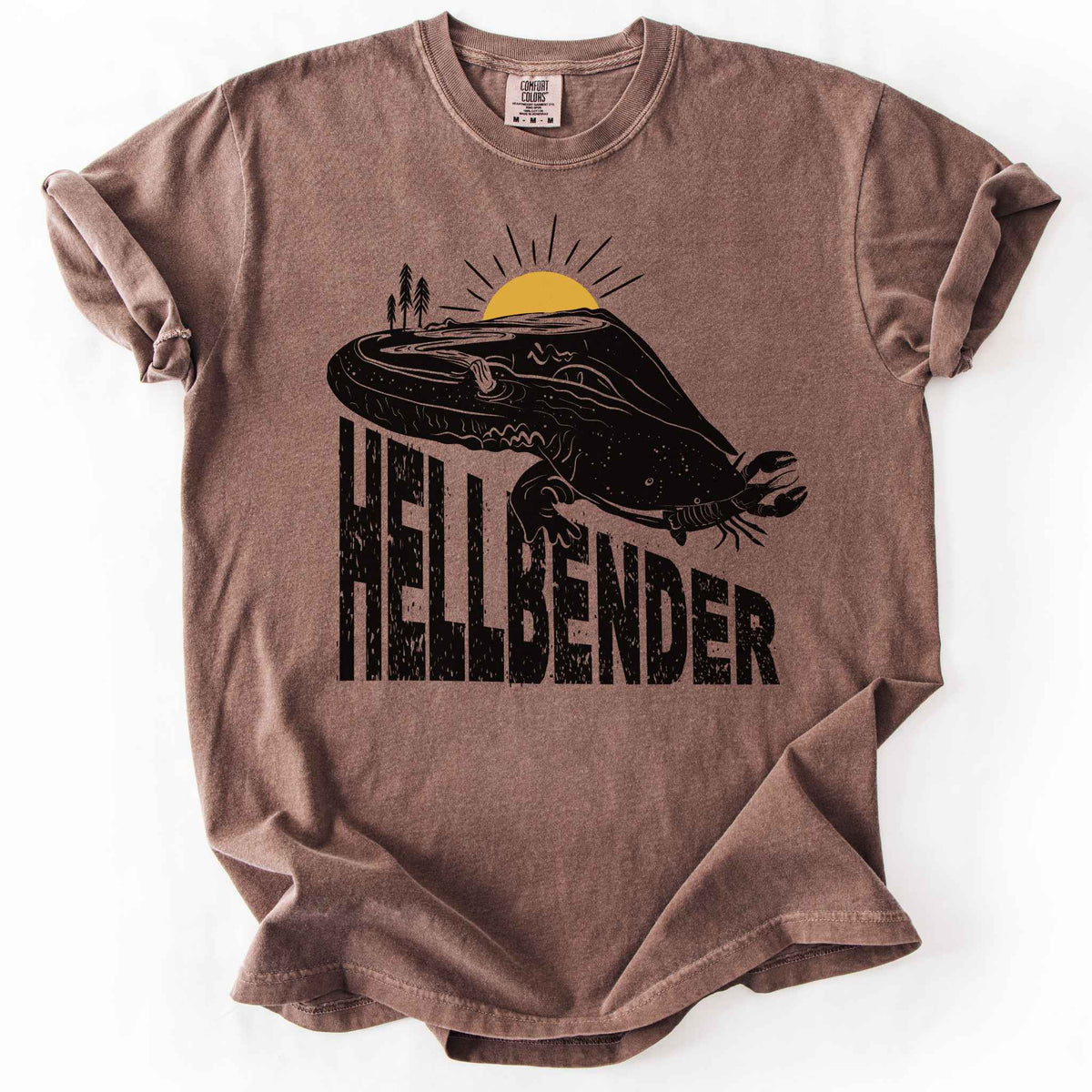 Espresso "Hellbender a body of water" t-shirt on Comfort Colors tee, featuring a bold black graphic of a hellbender salamander eating a crayfish with a river landscape etched into its body. Amphibian and herpetology lover gift shirt for salamander and river conservation enthusiasts.