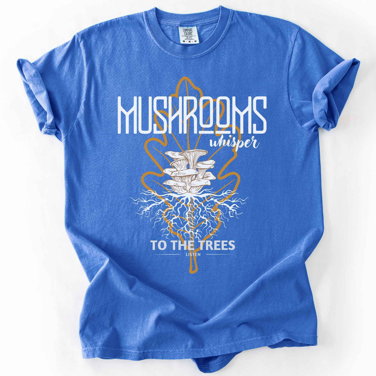 Flo Blue "Mushrooms Whisper to the Trees, Listen" t-shirt on Comfort Colors tee, featuring mushrooms growing from a mycelium root system inside a golden leaf outline. Mycology and forest lover gift shirt for foragers and mushroom enthusiasts.