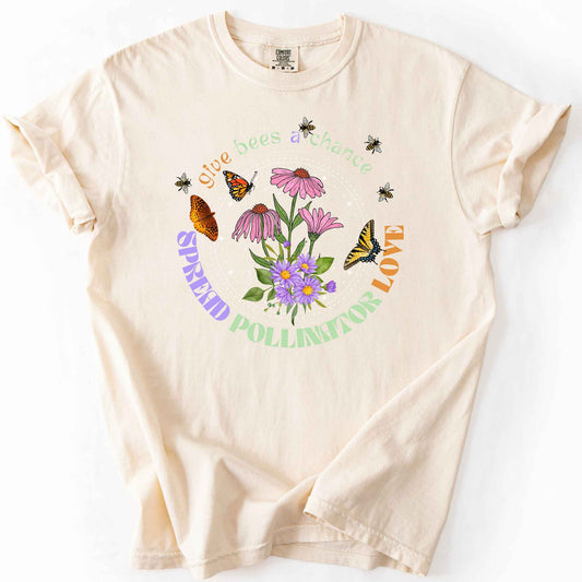 Ivory "Give Bees a Chance, Spread Pollinator Love" t-shirt on Comfort Colors tee, featuring colorful wildflowers, bees, and butterflies in a celestial circle design — gardener and nature lover gift shirt for bee and pollinator conservation fans.