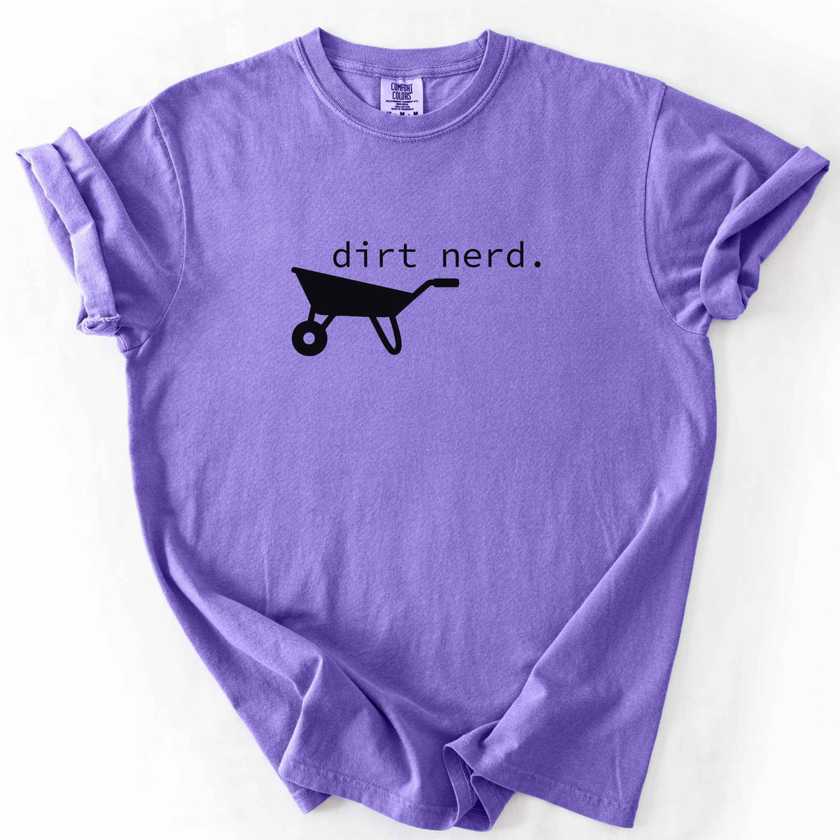Violet "Dirt Nerd" t-shirt on Comfort Colors tee, featuring a simple black wheelbarrow icon with minimalist typewriter style text. Funny gardener gift shirt for plant lovers and landscaping enthusiasts.