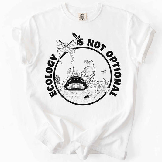 White "Ecology Is Not Optional" t-shirt on Comfort Colors tee, featuring a black circle badge with a box turtle, bird, luna moth, frog, and mushrooms in an ecosystem scene. Nature lover and biology gift shirt for ecologists and conservation enthusiasts.