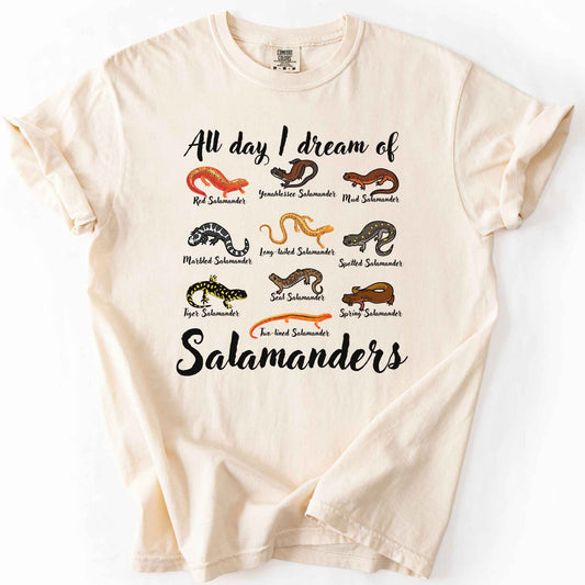 All Day I Dream of Salamanders ivory t-shirt on Comfort Colors tee, featuring 10 illustrated salamander species including Red, Tiger, Spotted, and Marbled Salamanders, with black script text, nature lover and herpetology gift shirt.