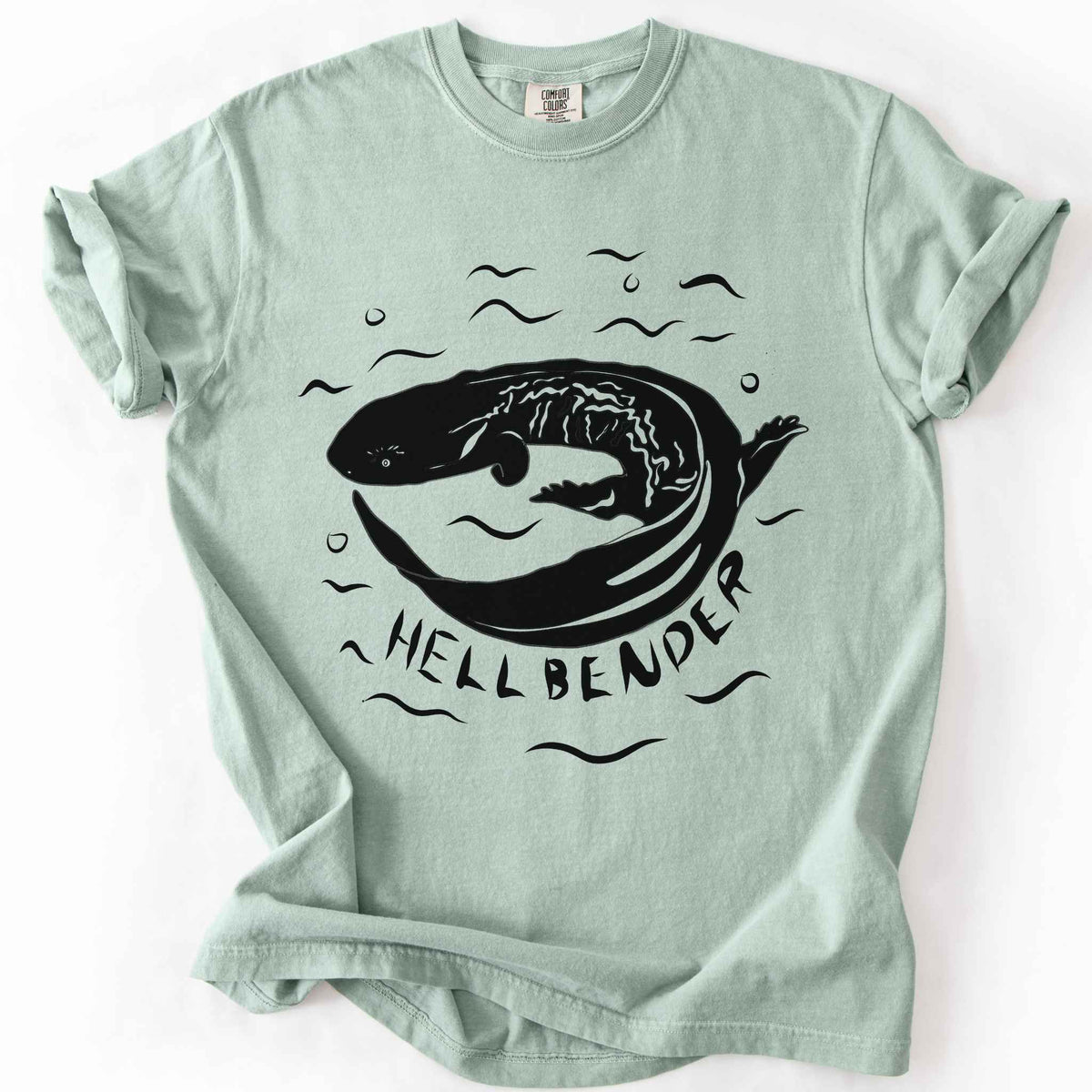 Bay "Hellbender" t-shirt on Comfort Colors tee, featuring a bold graphic of a curled hellbender salamander surrounded by stylized water splashes and bubbles. Amphibian and herpetology lover gift shirt for salamander and wildlife enthusiasts.