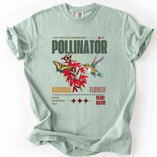 Bay "Pollinator, Ruby Throated Hummingbird, Cardinal Flower" t-shirt on Comfort Colors tee, featuring a hummingbird and swallowtail butterfly on red cardinal flowers with retro poster style text. Gardener and native plant gift shirt for birdwatching and pollinator conservation fans.