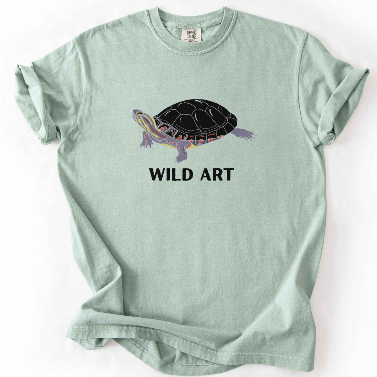 Bay "Wild Art" t-shirt on Comfort Colors tee, featuring a bold graphic of a painted turtle with bold black text below. Reptile lover and turtle enthusiast gift shirt for wildlife and nature fans.