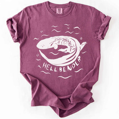 Berry "Hellbender" t-shirt on Comfort Colors tee, featuring a bold graphic of a curled hellbender salamander surrounded by stylized water splashes and bubbles. Amphibian and herpetology lover gift shirt for salamander and wildlife enthusiasts.