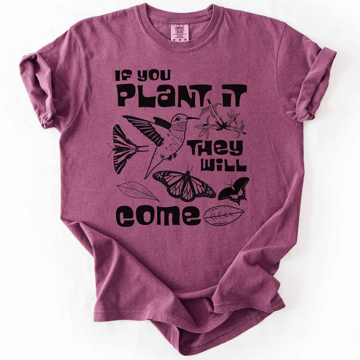 Berry "If You Plant It, They Will Come" t-shirt on Comfort Colors tee, featuring a hummingbird surrounded by butterflies and flowers with bold black lettering and line art style. Gardener and native plant gift shirt for pollinator conservation fans.