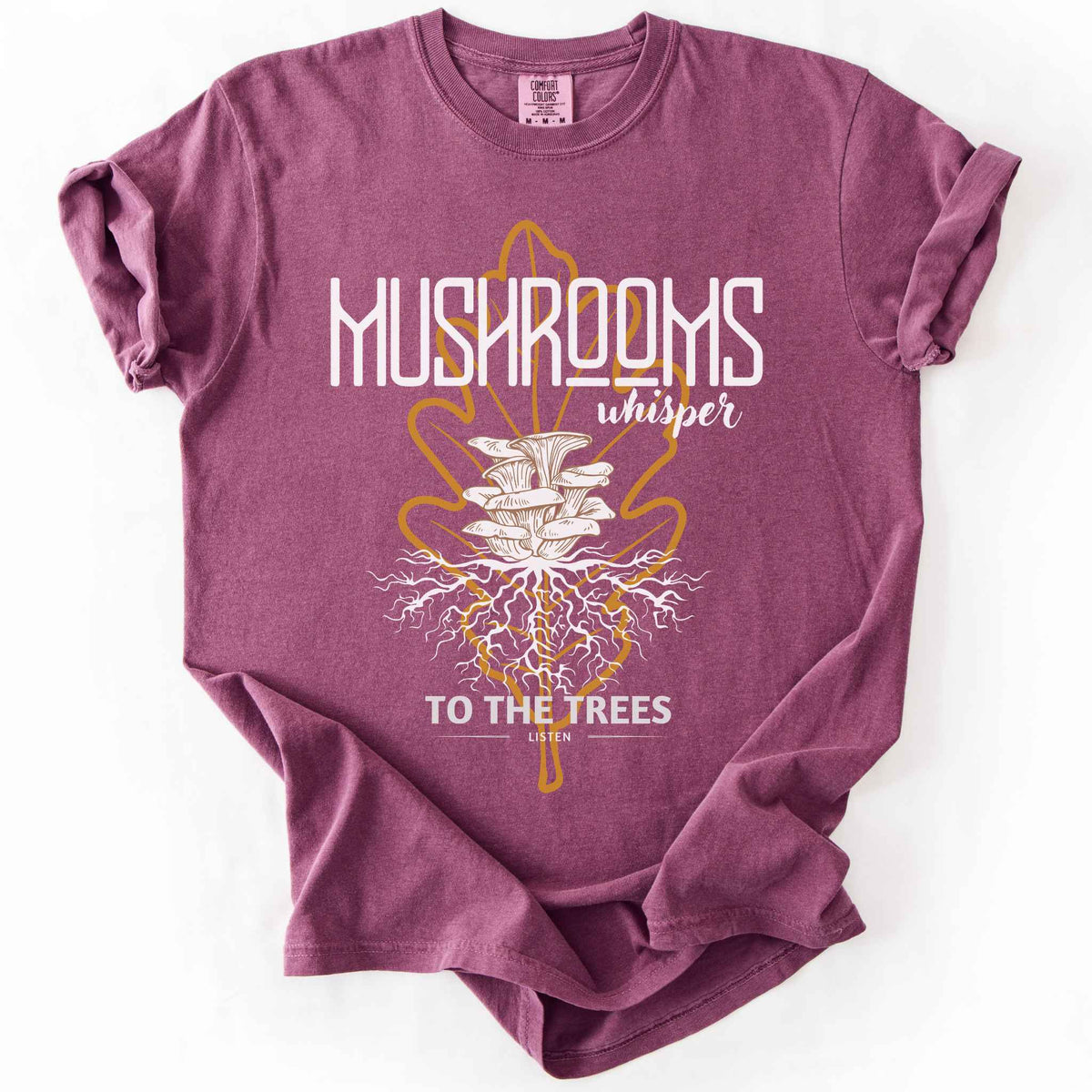 Berry "Mushrooms Whisper to the Trees, Listen" t-shirt on Comfort Colors tee, featuring mushrooms growing from a mycelium root system inside a golden leaf outline. Mycology and forest lover gift shirt for foragers and mushroom enthusiasts.