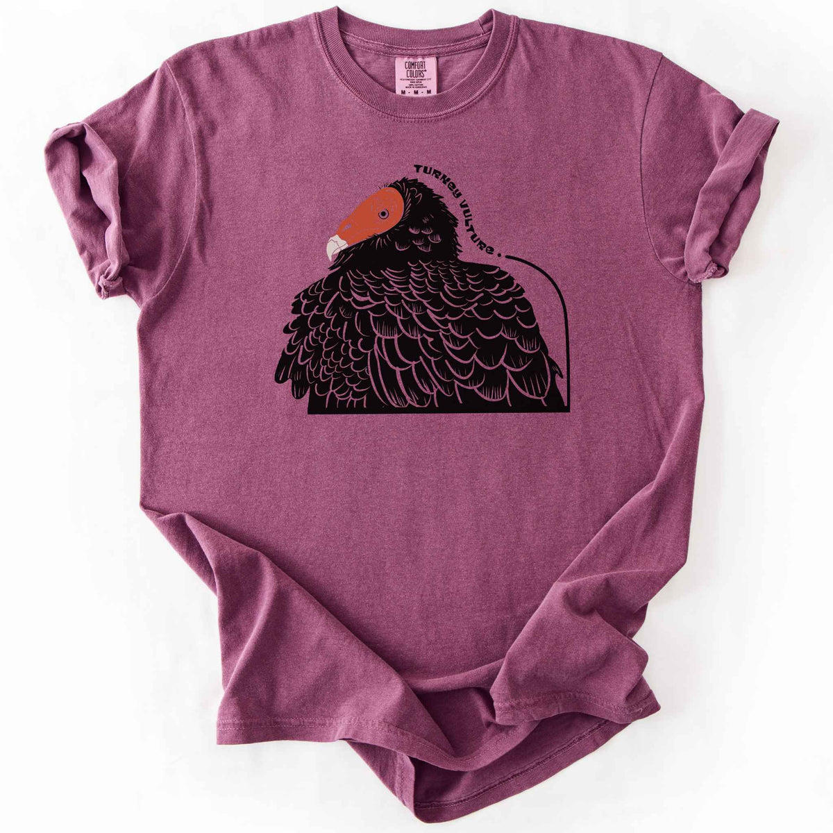 Berry "Turkey Vulture" t-shirt on Comfort Colors tee, featuring a bold illustrated portrait of a turkey vulture with a curved text label. Birdwatcher and scavenger lover gift shirt for wildlife and nature enthusiasts.