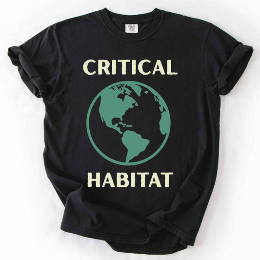 Black "Critical Habitat" t-shirt on Comfort Colors tee, featuring a bold green globe graphic with cream lettering. Conservation and environmentalist gift shirt for earth science and wildlife protection advocates.