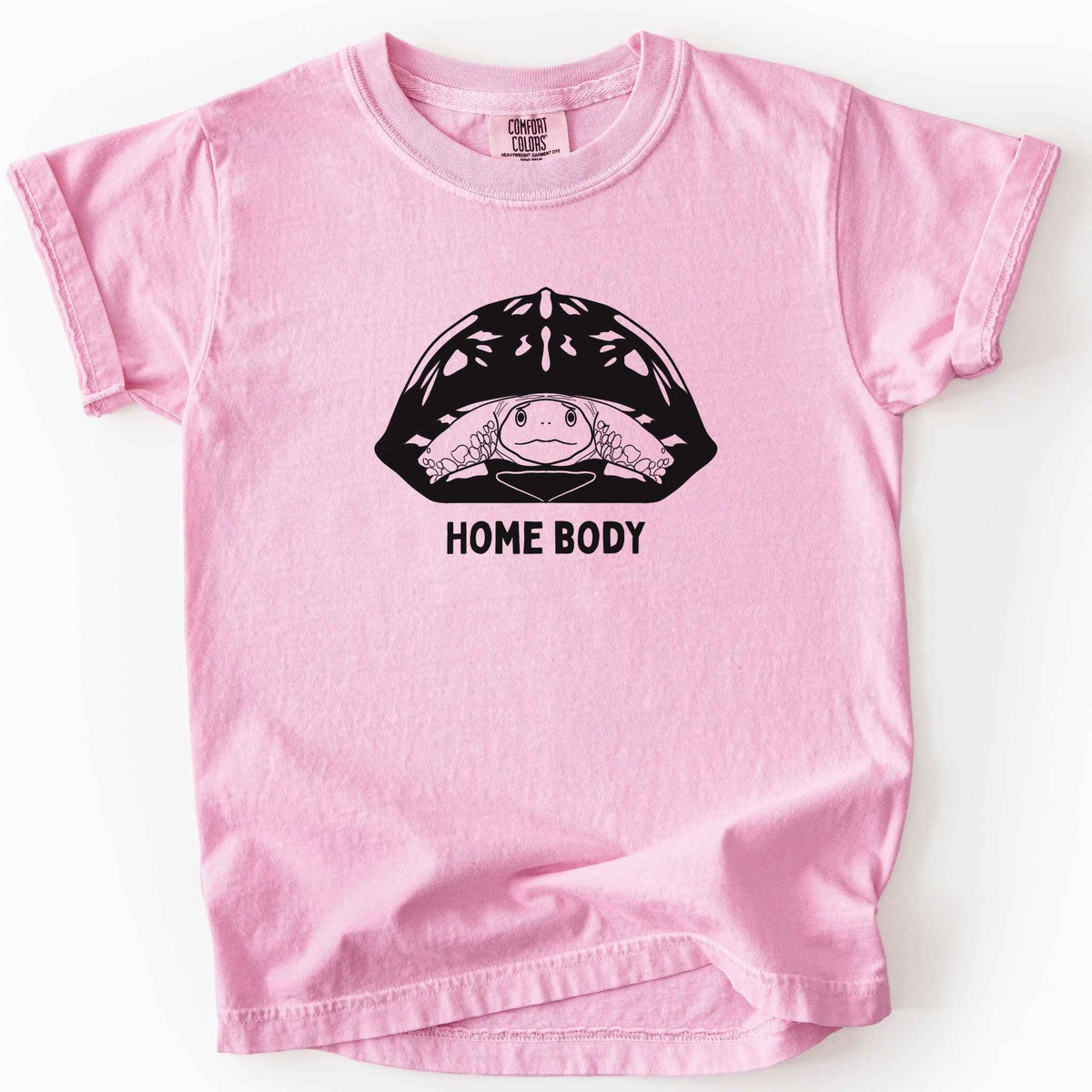 Blossom "Home Body" kids t-shirt on Comfort Colors tee, featuring a bold black graphic of a turtle peeking out from its shell above simple lettering. Funny turtle lover gift shirt for introverts and reptile enthusiasts.
