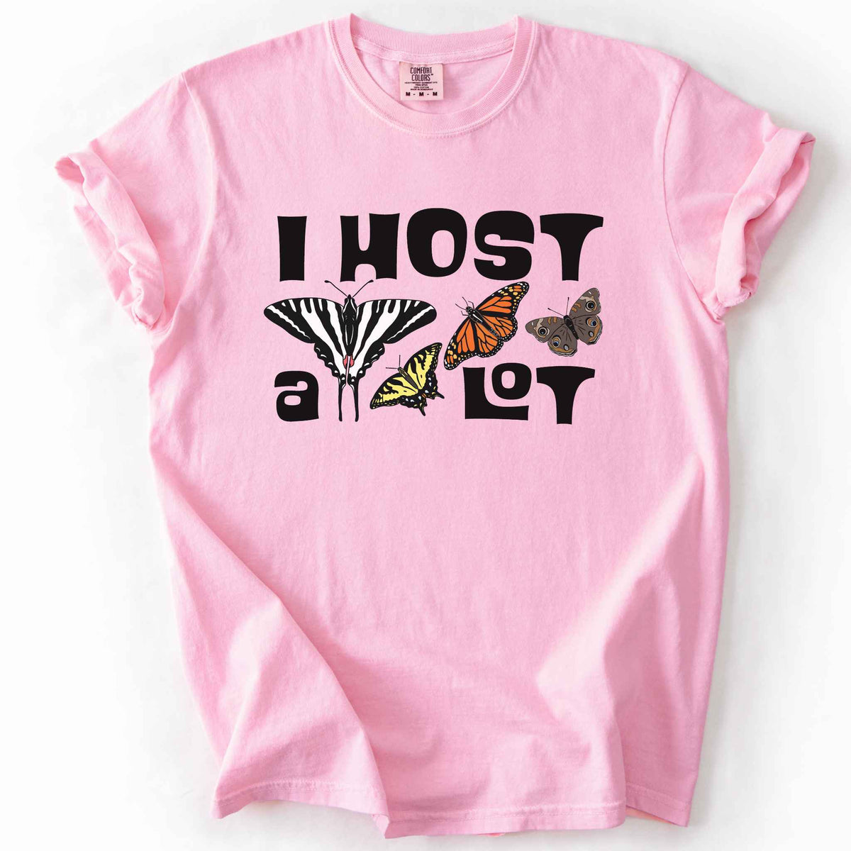Blossom "I Host a Lot" t-shirt on Comfort Colors tee, featuring four butterfly species graphics including a Zebra Swallowtail and Monarch with bold black lettering text. Funny gardener and butterfly host plant gift shirt for pollinator enthusiasts.