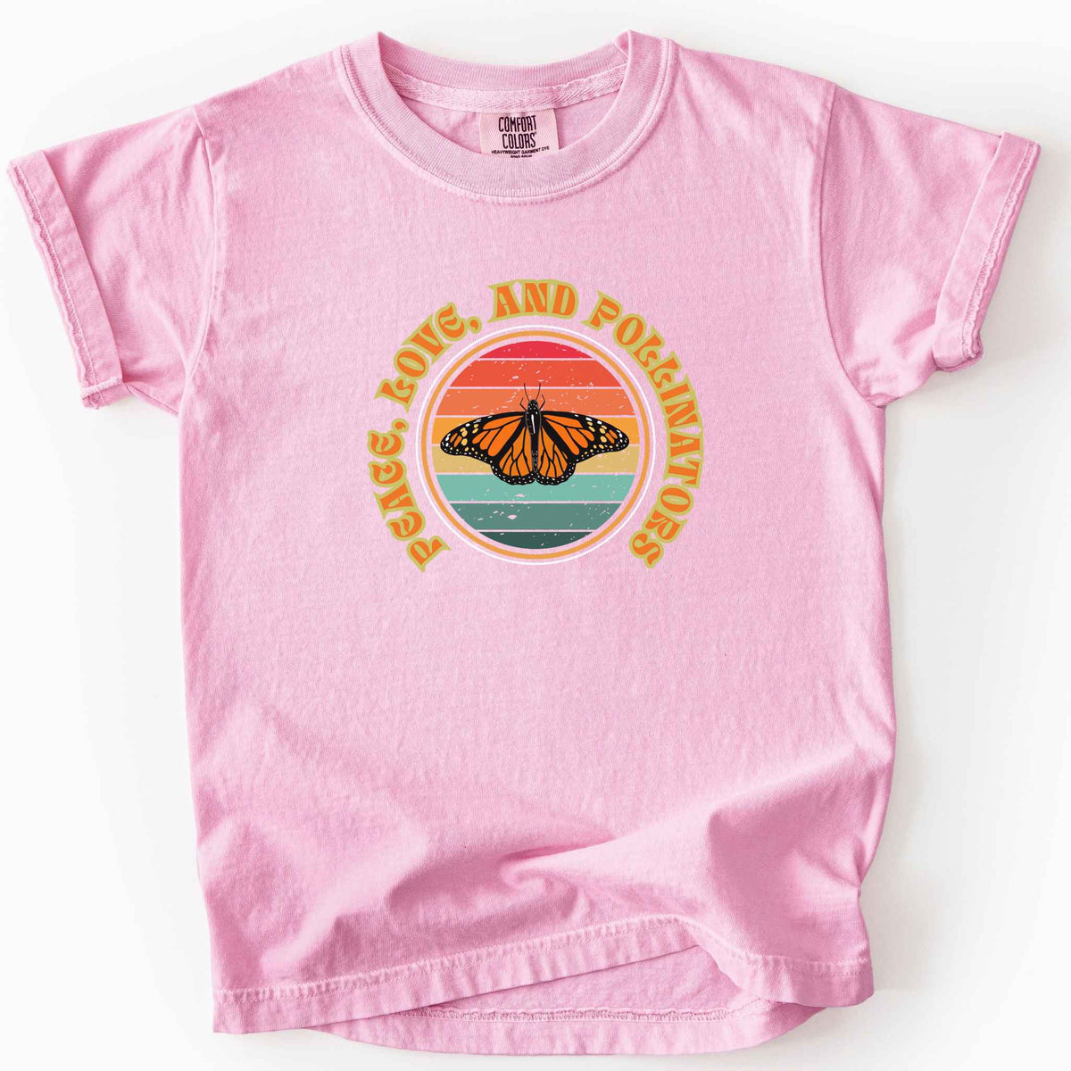 Blossom "Peace, Love, and Pollinators" kids t-shirt on Comfort Colors tee, featuring a monarch butterfly against a retro rainbow sunset circle design. Butterfly gardener and native plant gift shirt for pollinator conservation fans.