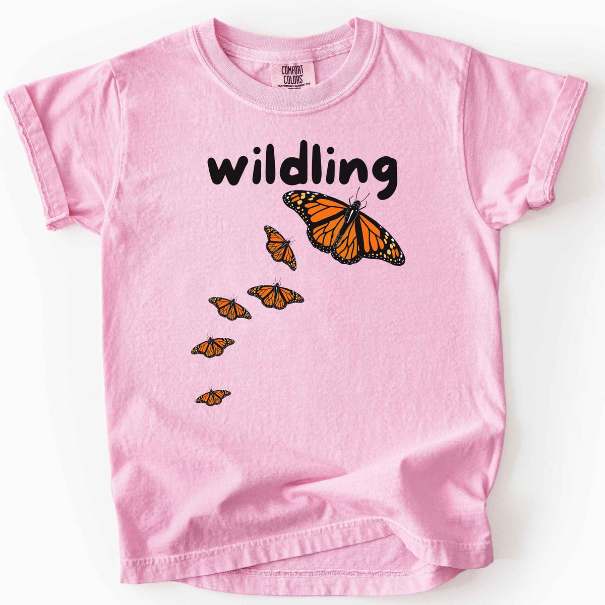Blossom "Wildling" kids t-shirt on Comfort Colors Tee featuring six Monarch butterflies in an upward ascending pattern and bold black text. Nature inspired gift for kids and butterfly enthusiasts. 