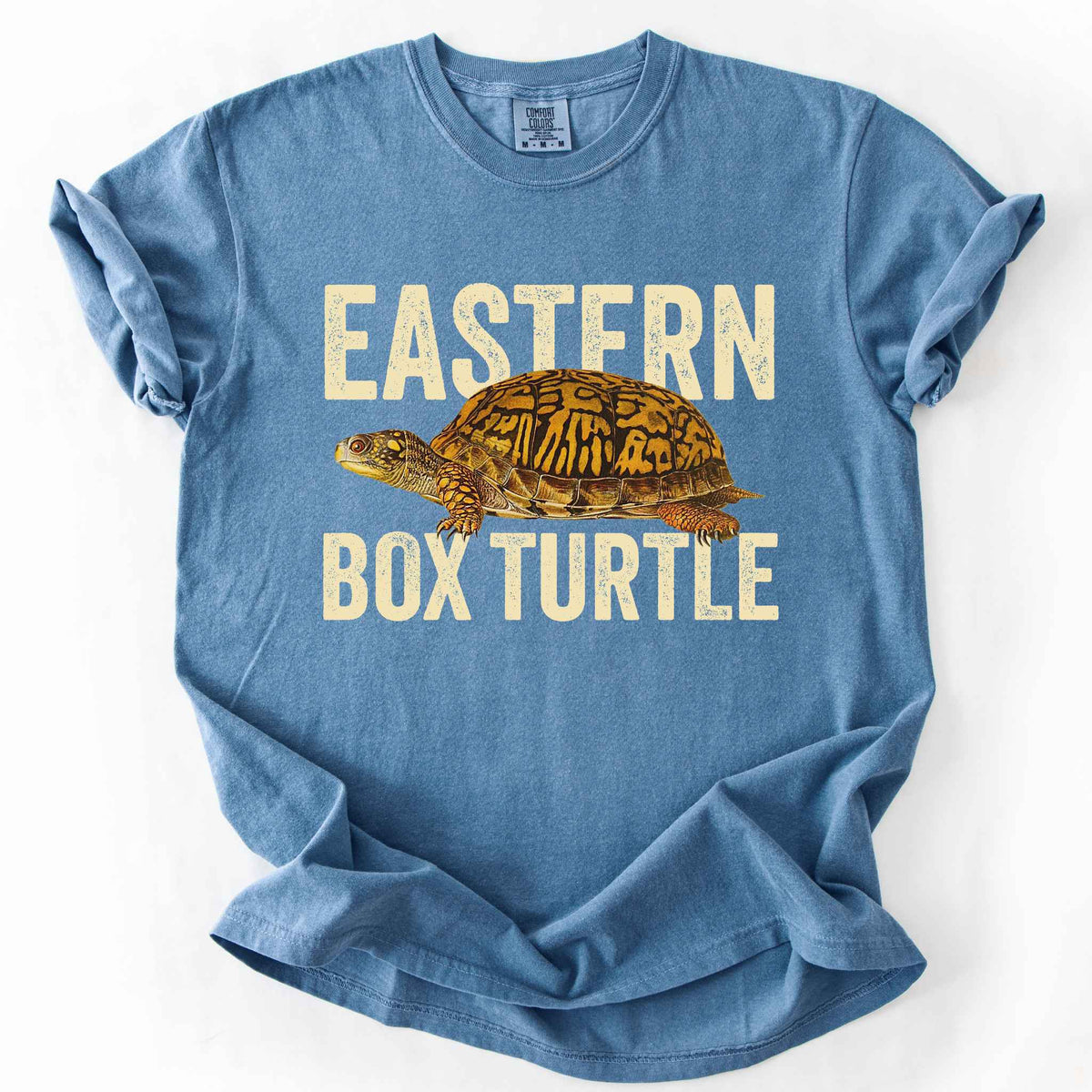 Blue Jean "Eastern Box Turtle" t-shirt on Comfort Colors tee, featuring a detailed vintage style turtle graphic with cream bold block lettering. Reptile lover and turtle enthusiast gift shirt for wildlife and nature fans.