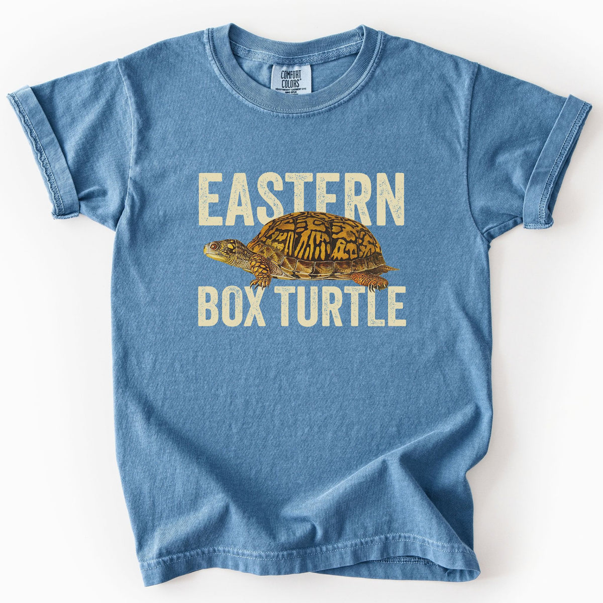 Blue jean "Eastern Box Turtle" kids t-shirt on Comfort Colors tee, featuring a detailed vintage style turtle graphic with cream bold block lettering. Reptile lover and turtle enthusiast gift shirt for wildlife and nature fans.