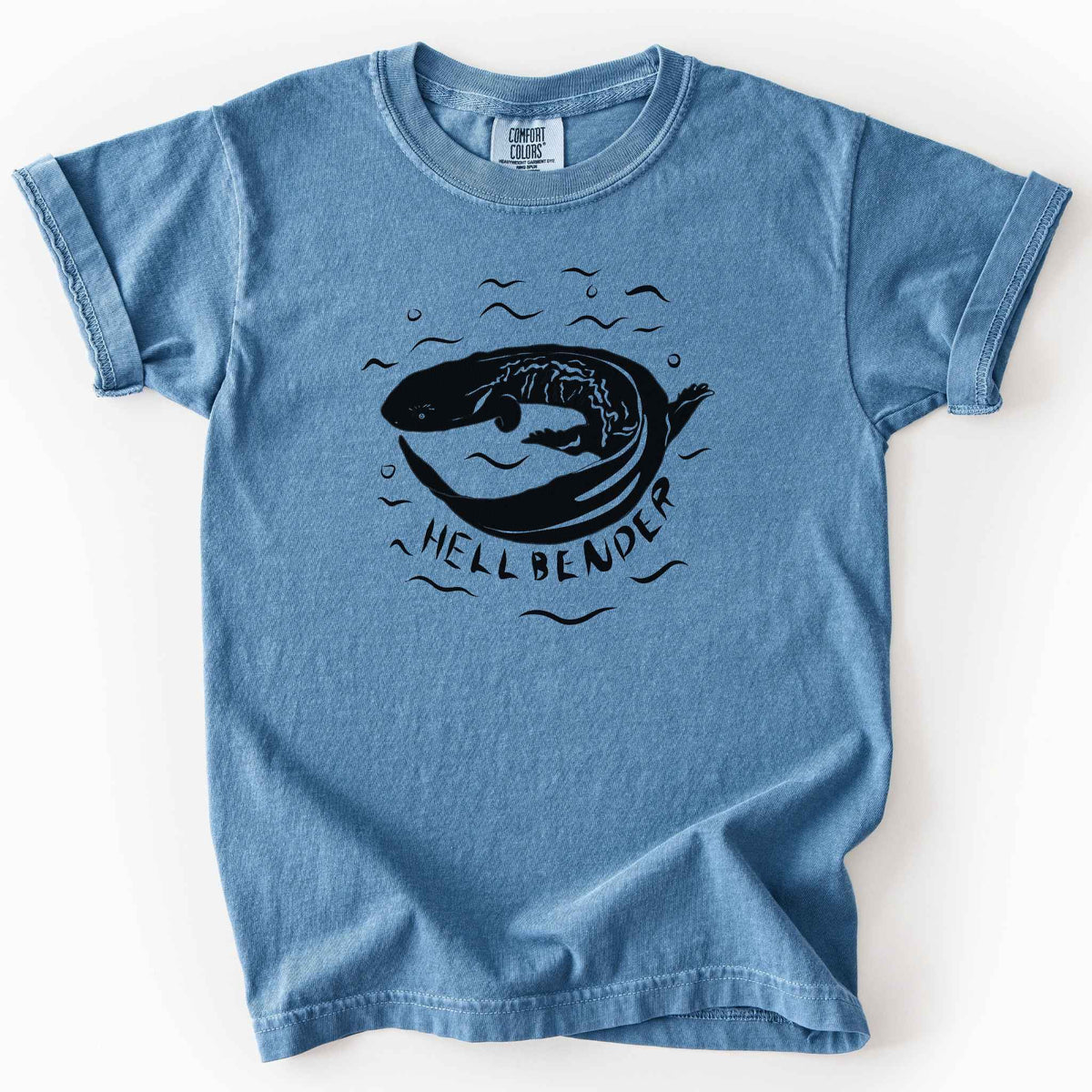 Blue jean "Hellbender" kids t-shirt on Comfort Colors tee, featuring a bold graphic of a curled hellbender salamander surrounded by stylized water splashes and bubbles. Amphibian and herpetology lover gift shirt for salamander and wildlife enthusiasts.