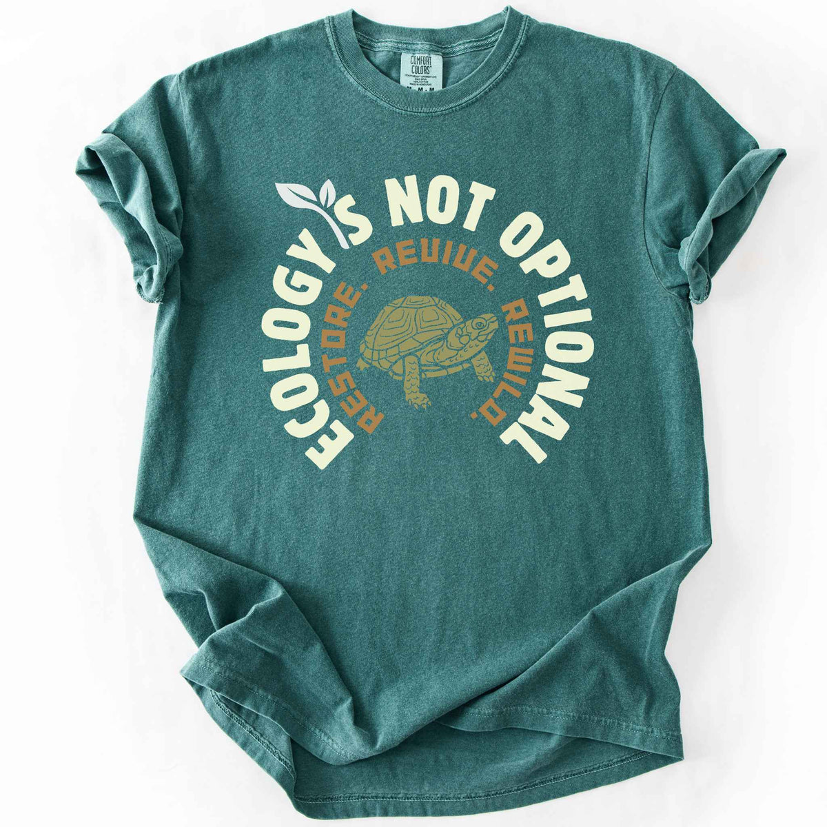 Blue spruce "Ecology Is Not Optional, Restore, Revive, Rewild" t-shirt on Comfort Colors tee, featuring a box turtle illustration within a circular design. Conservation and reptile lover gift shirt for ecologists and wildlife enthusiasts.