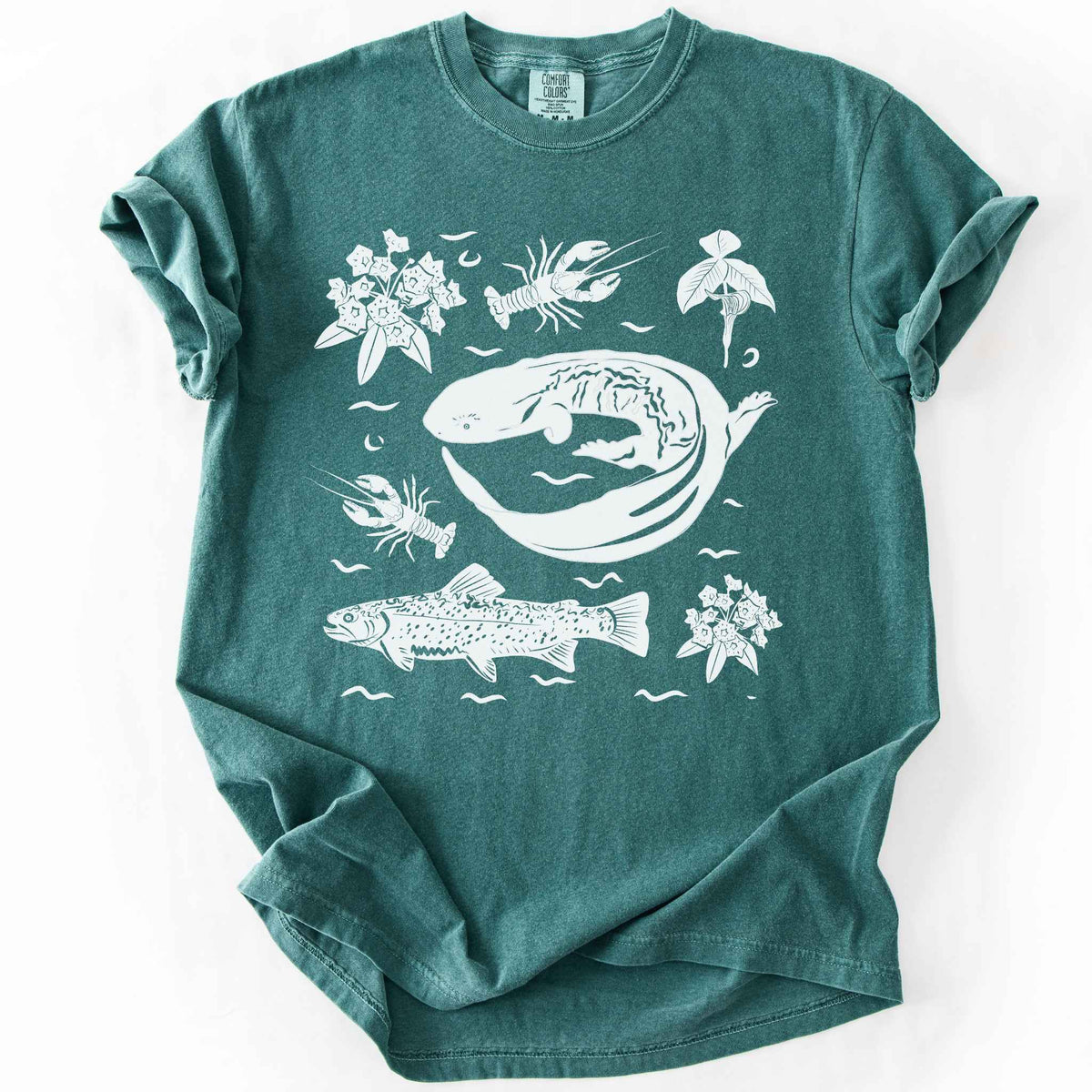 Blue spruce "Hellbender Ecology" t-shirt on Comfort Colors tee, featuring a curled hellbender salamander surrounded by hand-drawn crayfish, trout, and mountain laurel. Amphibian and river ecosystem gift shirt for herpetology and fly fishing enthusiasts.