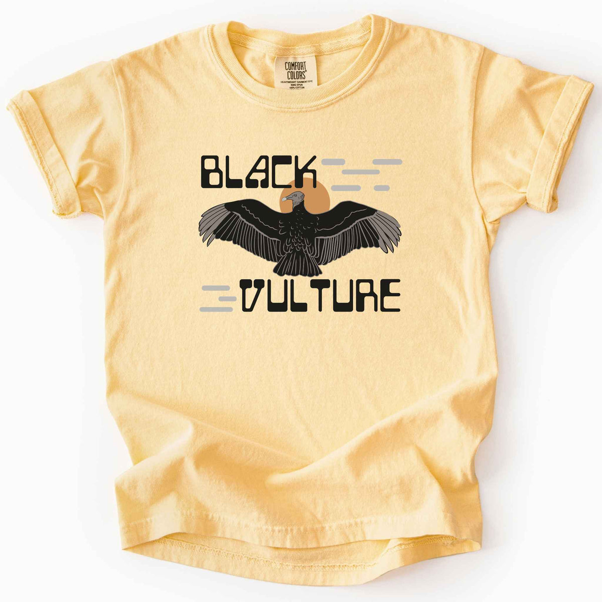 Butter "Black Vulture" kids t-shirt on Comfort Colors tee, featuring a vulture with spread wings against an orange sun with bold geometric lettering. Birdwatcher and scavenger lover gift shirt for wildlife and nature enthusiasts.