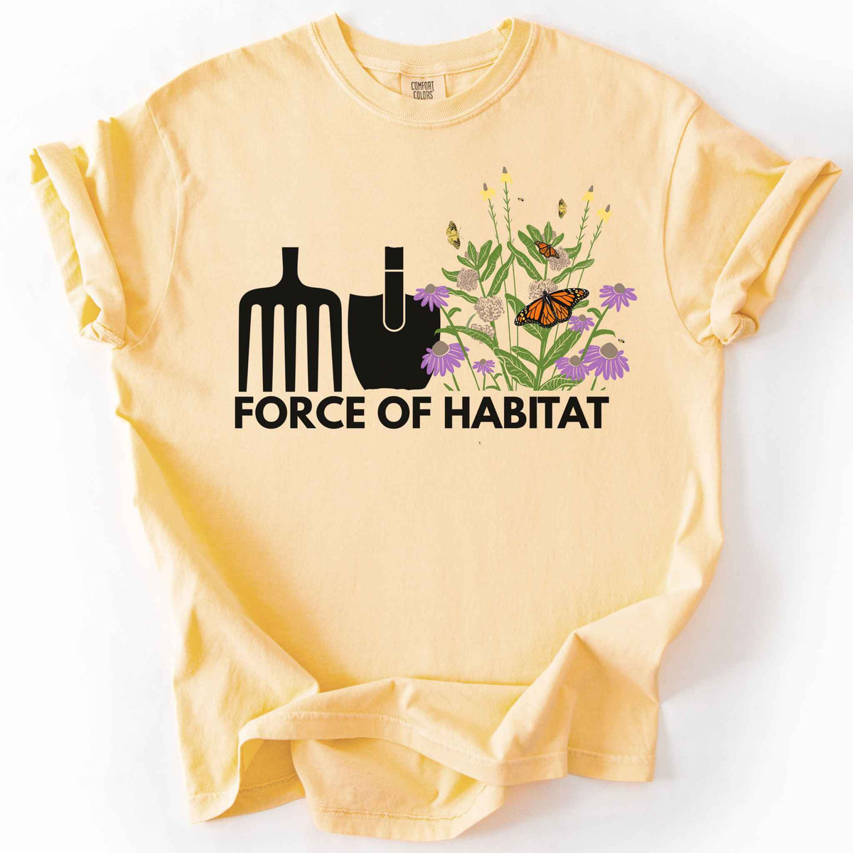 Butter "Force of Habitat" t-shirt on Comfort Colors tee, featuring simple garden tool graphics beside a coneflower and milkweed patch with monarch and fritillary butterflies. Gardener and native plant gift shirt for pollinator conservation fans.
