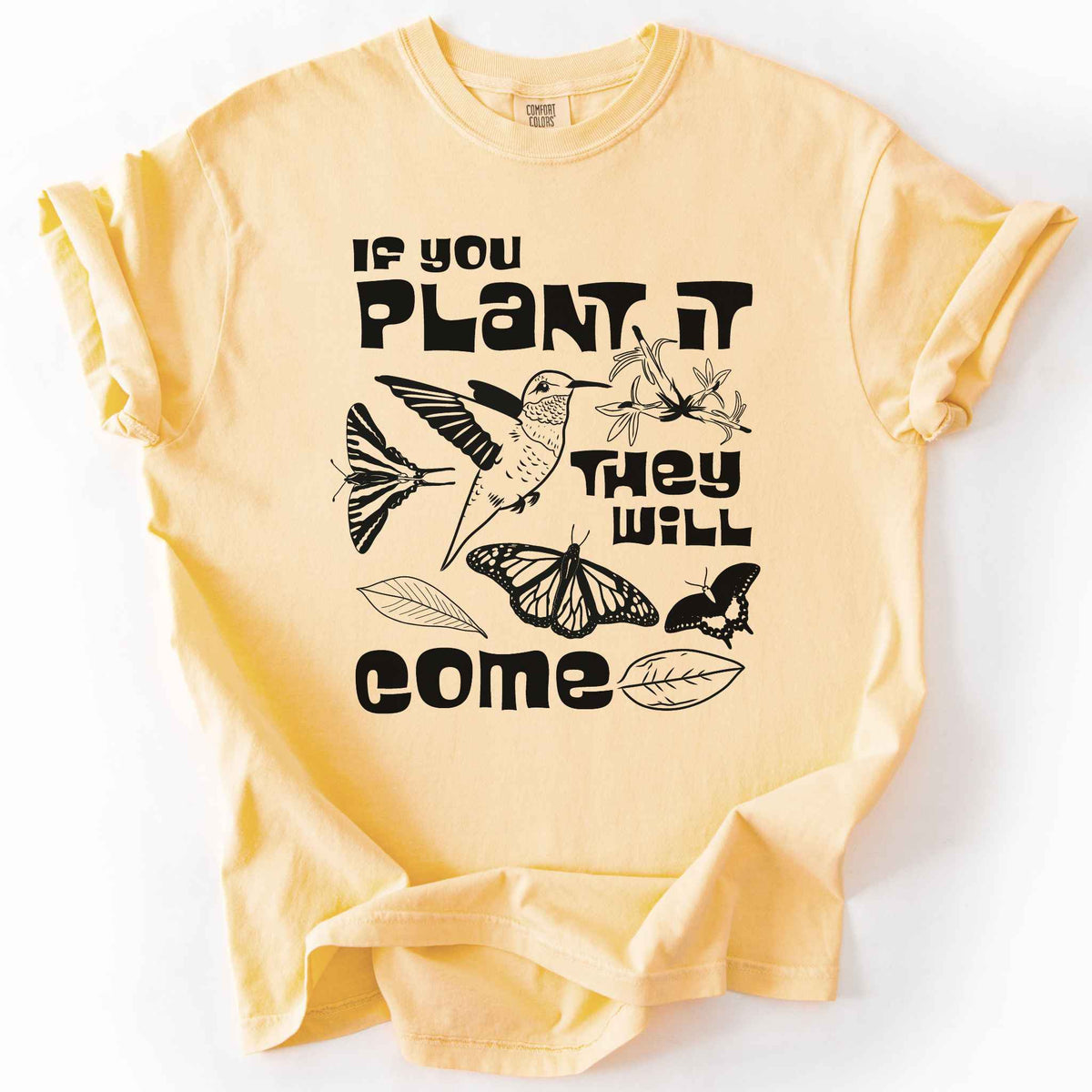 Butter "If You Plant It, They Will Come" t-shirt on Comfort Colors tee, featuring a hummingbird surrounded by butterflies and flowers with bold black lettering and line art style. Gardener and native plant gift shirt for pollinator conservation fans.
