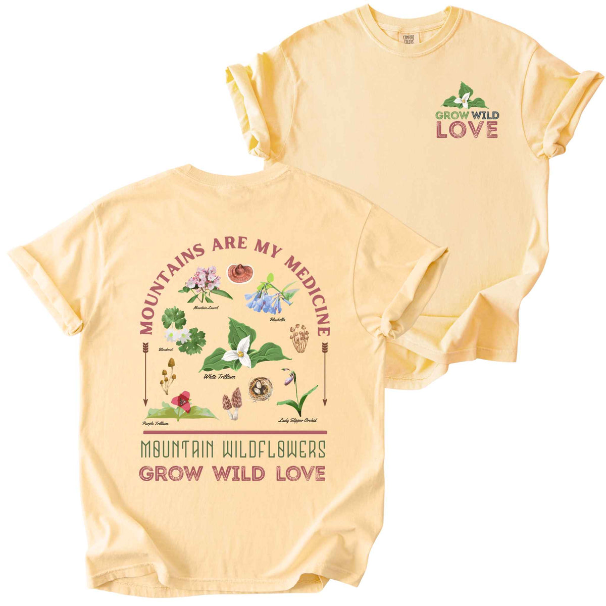 Butter "Mountains Are My Medicine, Mountain Wildflowers, Grow Wild Love" t-shirt on Comfort Colors tee, featuring a small front chest logo and a full illustrated back print of labeled wildflowers and mushrooms including Trillium, Bluebells, and Lady Slipper Orchid. Botanical gift shirt for hikers and wildflower enthusiasts.