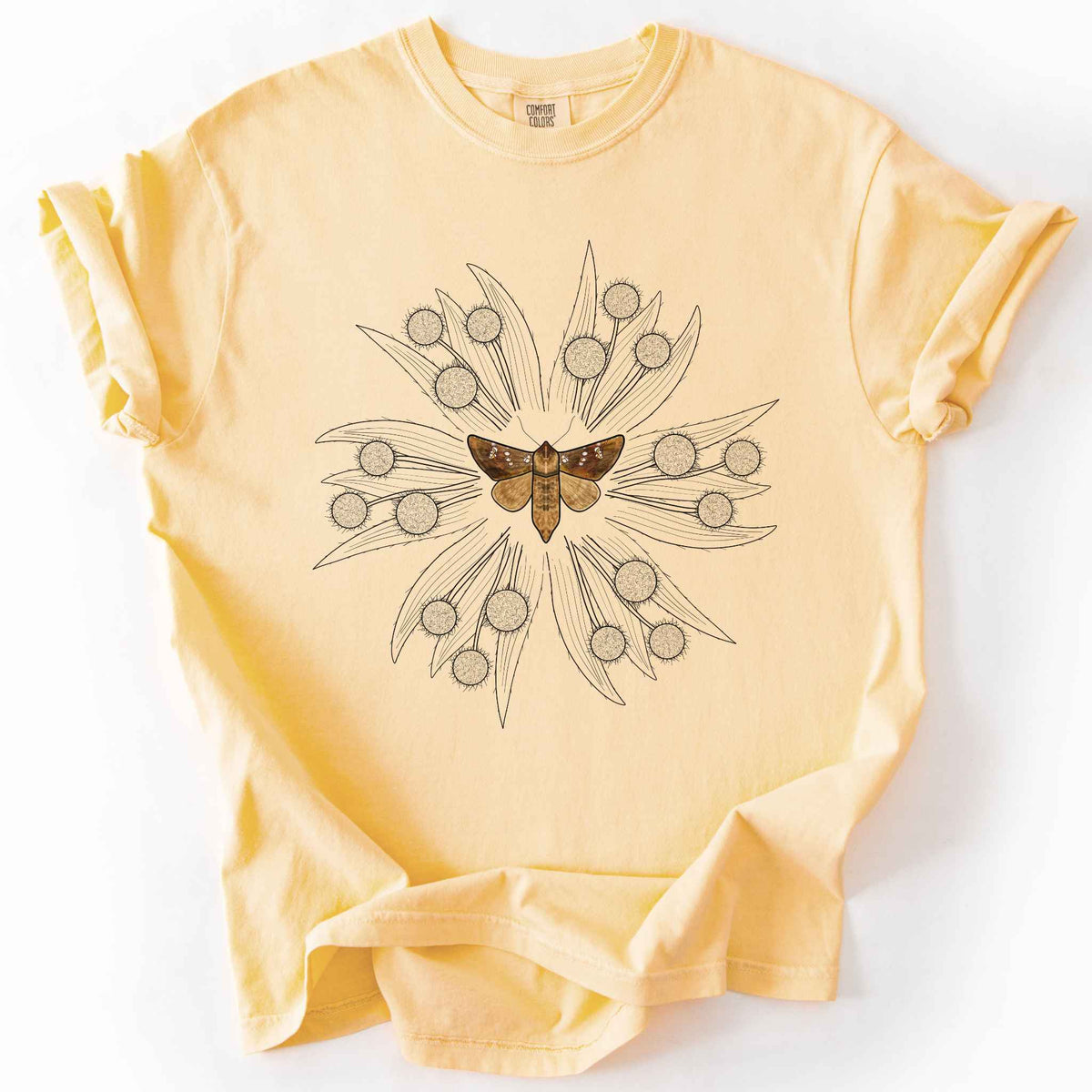 Butter endangered moth t-shirt on Comfort Colors tee, featuring a realistic Rattlesnake Master Borer Moth (Papaipema eryngii) at the center of a mandala style burst of hand drawn thistle flowers. Nature lover and moth enthusiast gift shirt for entomology and botanical illustration fans.