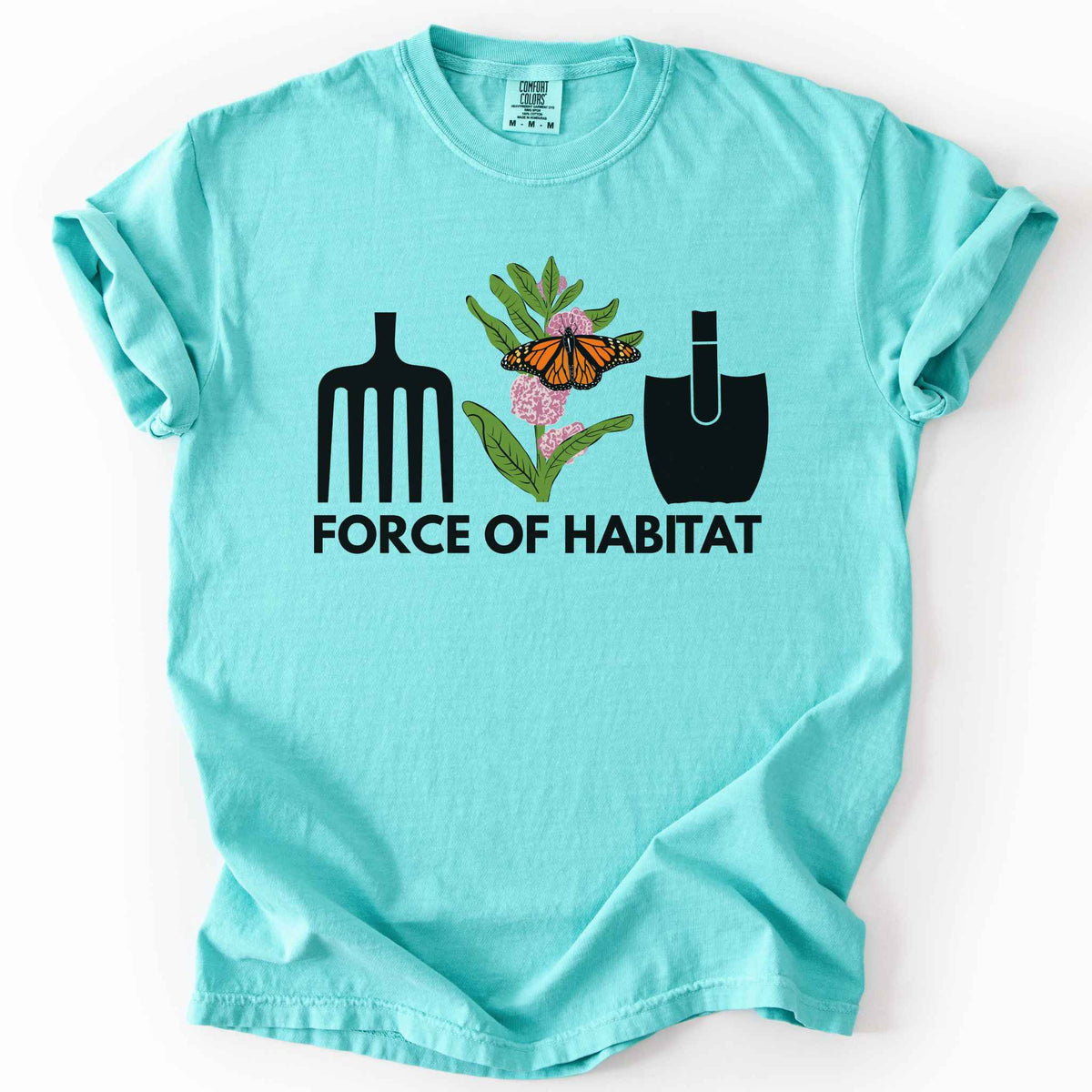 Chalky mint "Force of Habitat: monarch" t-shirt on Comfort Colors tee, featuring garden tool graphics flanking a hand-drawn monarch butterfly on milkweed flowers with bold black text below. Gardener and native plant gift shirt for pollinator conservation fans.