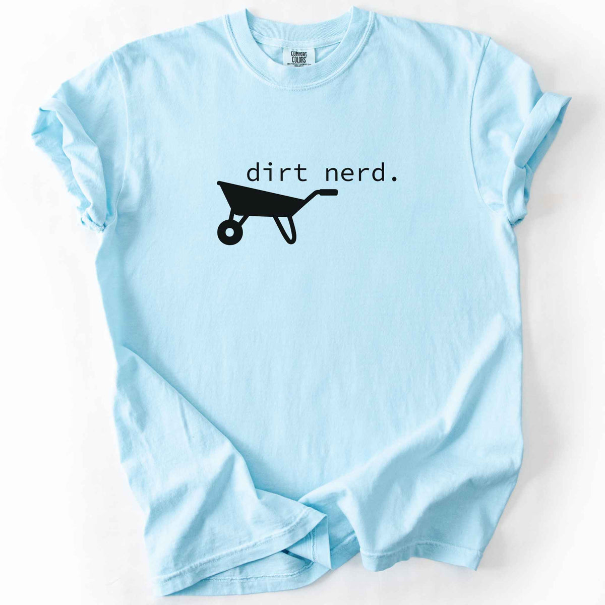 Chambray "Dirt Nerd" t-shirt on Comfort Colors tee, featuring a simple black wheelbarrow icon with minimalist typewriter style text. Funny gardener gift shirt for plant lovers and landscaping enthusiasts.
