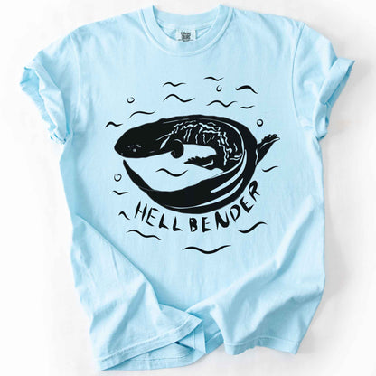 Chambray "Hellbender" t-shirt on Comfort Colors tee, featuring a bold graphic of a curled hellbender salamander surrounded by stylized water splashes and bubbles. Amphibian and herpetology lover gift shirt for salamander and wildlife enthusiasts.