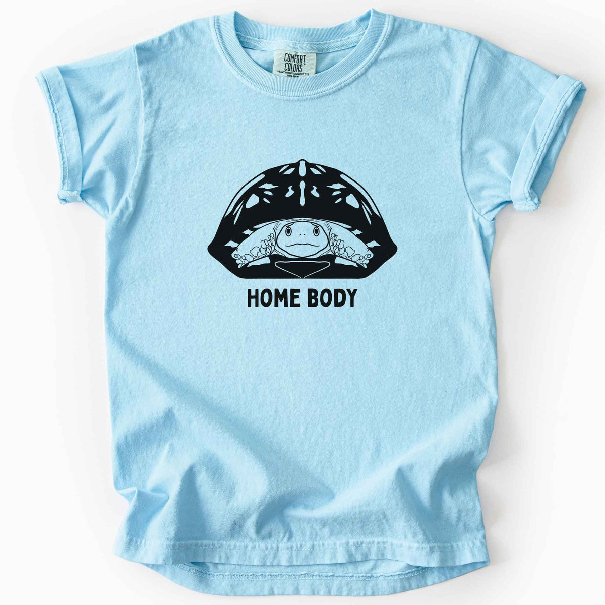 Chambray "Home Body" kids t-shirt on Comfort Colors tee, featuring a bold black graphic of a turtle peeking out from its shell above simple lettering. Funny turtle lover gift shirt for introverts and reptile enthusiasts.