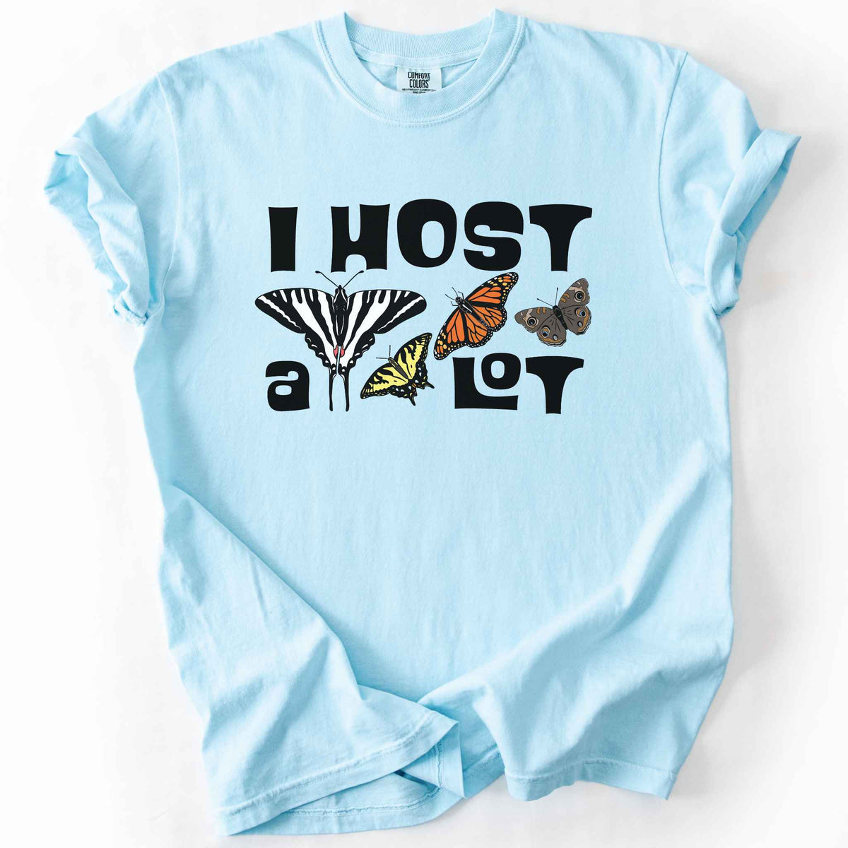 Chambray "I Host a Lot" t-shirt on Comfort Colors tee, featuring four butterfly species graphics including a Zebra Swallowtail and Monarch with bold black lettering text. Funny gardener and butterfly host plant gift shirt for pollinator enthusiasts.