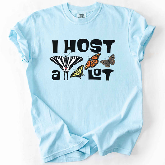 Chambray "I Host a Lot" t-shirt on Comfort Colors tee, featuring four butterfly species graphics including a Zebra Swallowtail and Monarch with bold black lettering text. Funny gardener and butterfly host plant gift shirt for pollinator enthusiasts.