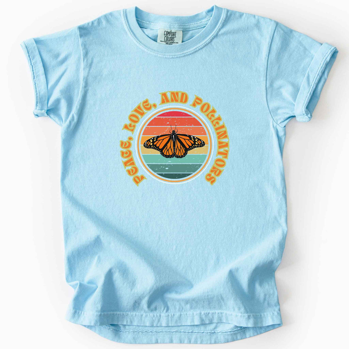 Chambray "Peace, Love, and Pollinators" kids t-shirt on Comfort Colors tee, featuring a monarch butterfly against a retro rainbow sunset circle design. Butterfly gardener and native plant gift shirt for pollinator conservation fans.
