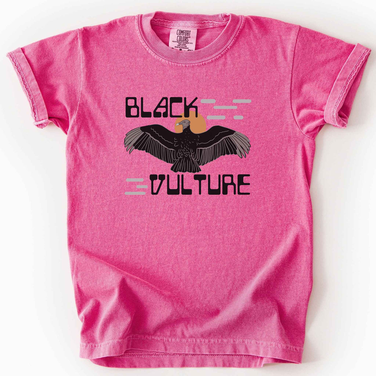 Crunchberry "Black Vulture" kids t-shirt on Comfort Colors tee, featuring a vulture with spread wings against an orange sun with bold geometric lettering. Birdwatcher and scavenger lover gift shirt for wildlife and nature enthusiasts.