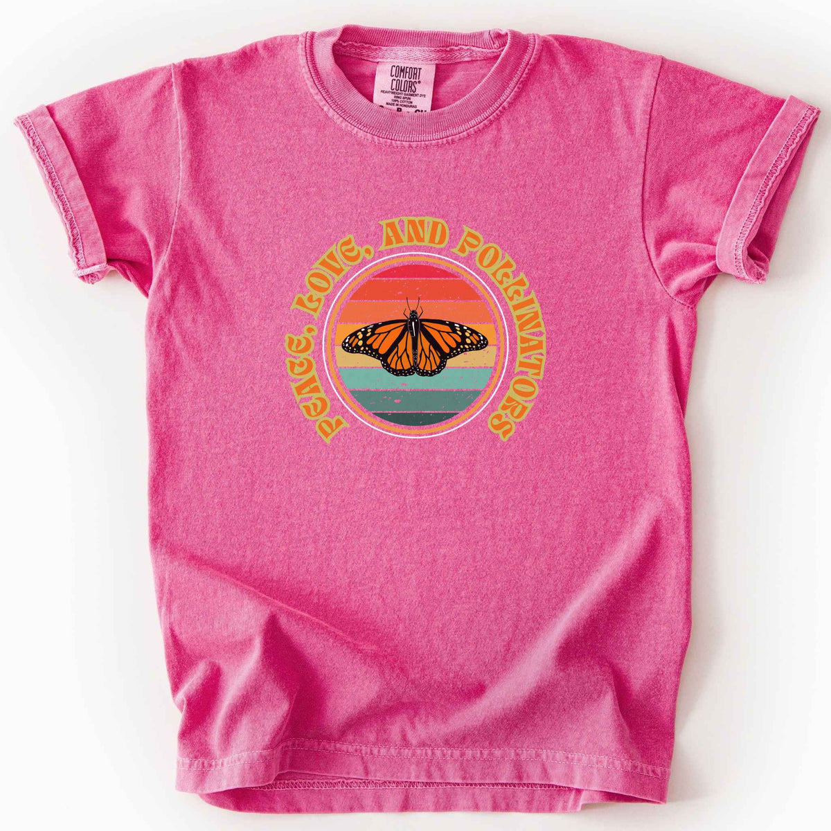 Crunchberry "Peace, Love, and Pollinators" kids t-shirt on Comfort Colors tee, featuring a monarch butterfly against a retro rainbow sunset circle design. Butterfly gardener and native plant gift shirt for pollinator conservation fans.