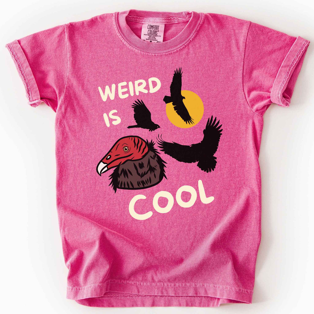 Crunchberry "Weird is cool" kids t-shirt on comfort colors tee featuring turkey vulture silhouettes and a hand-drawn profile graphic with bold white playful text. Gift for little beginning birders and wildlife enthusiasts. 
