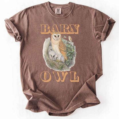 Espresso "Barn Owl" t-shirt on Comfort Colors tee, featuring a detailed graphic of a barn owl with owlets nestled in a tree hollow with ivy, in tan bold lettering. Birdwatcher and owl lover gift shirt for wildlife and nature enthusiasts.