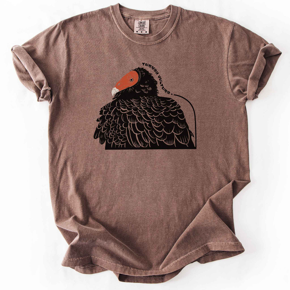 Espresso "Turkey Vulture" t-shirt on Comfort Colors tee, featuring a bold illustrated portrait of a turkey vulture with a curved text label. Birdwatcher and scavenger lover gift shirt for wildlife and nature enthusiasts.