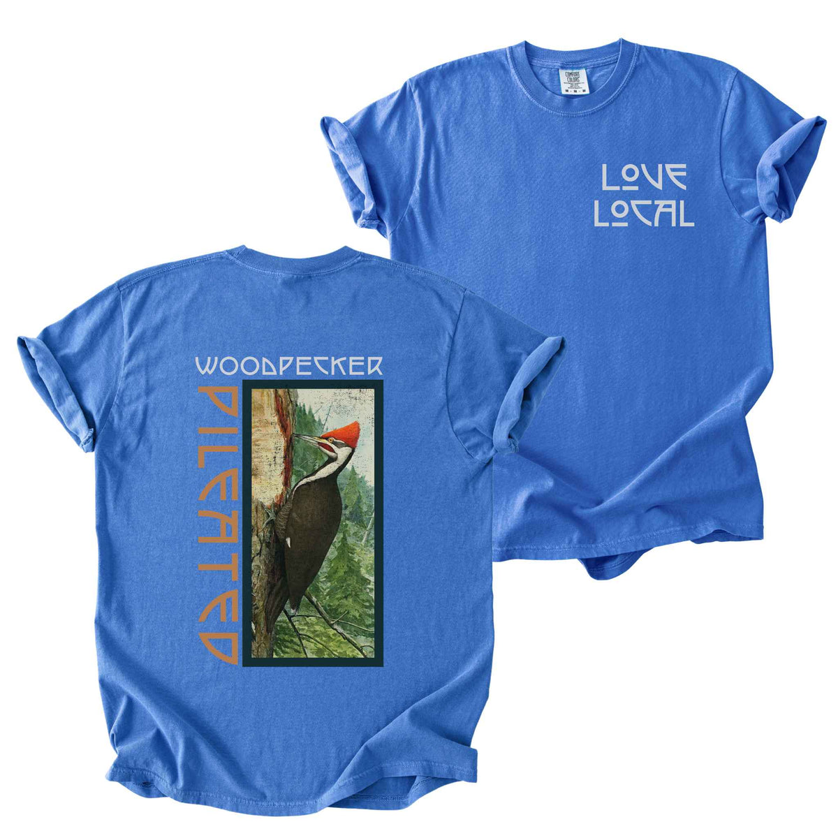 Flo blue "Pileated Woodpecker, Love Local" t-shirt on Comfort Colors tee, featuring a small front chest logo and a full vintage style back print of a woodpecker on a tree in a forest setting. Birdwatcher gift shirt for wildlife and nature enthusiasts.