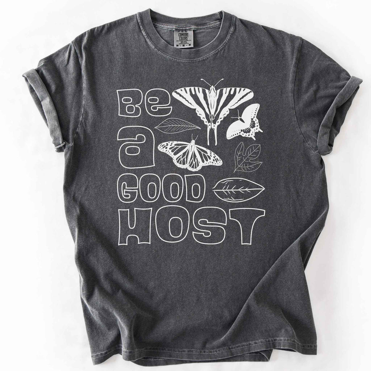 Graphite "Be a good host" t-shirt on Comfort colors with illustrations of zebra swallowtail and host plant paw paw leaf, spicebush swallowtail and one of its host plants sassafras leaf, and monarch and host plant milkweed leaf. Gift for wildlife gardeners and native plant enthusiasts.