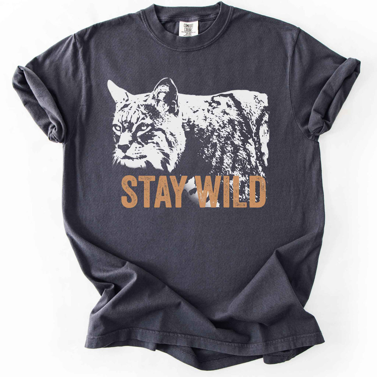 Graphite "Stay Wild" t-shirt on Comfort Colors tee, featuring a bold white bobcat graphic with orange lettering — wildlife lover and nature enthusiast gift shirt for outdoorsy, animal-inspired style. 