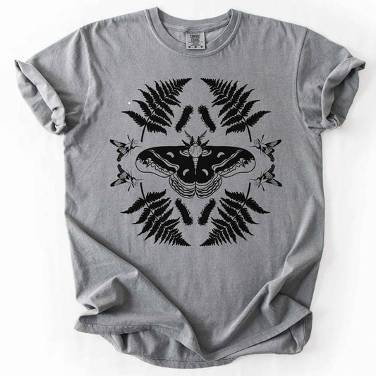 Grey "Cecropia moth" t-shirt on Comfort Colors tee, featuring a bold black symmetrical design of a moth surrounded by ferns and hummingbird moths in a mirrored botanical pattern. Nature lover and moth enthusiast gift shirt for entomology and cottagecore fans.