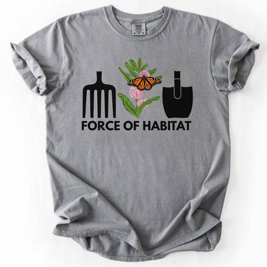 Grey "Force of Habitat:monarch" t-shirt on Comfort Colors tee, featuring garden tool graphics flanking a hand-drawn monarch butterfly on milkweed flowers with bold black text below. Gardener and native plant gift shirt for pollinator conservation fans.