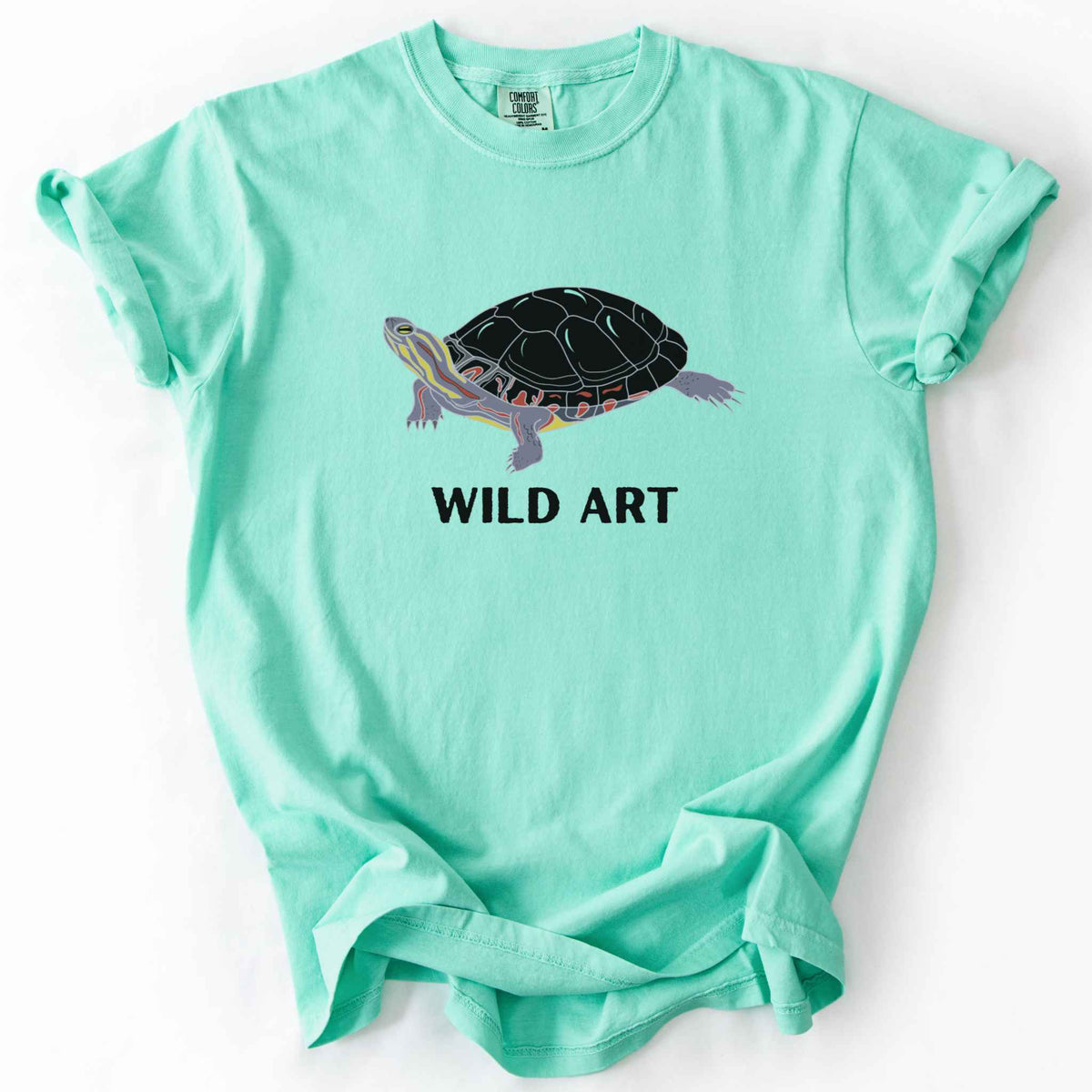 Island Reef "Wild Art" t-shirt on Comfort Colors tee, featuring a bold graphic of a painted turtle with bold black text below. Reptile lover and turtle enthusiast gift shirt for wildlife and nature fans.