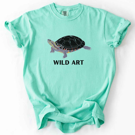 Island Reef "Wild Art" t-shirt on Comfort Colors tee, featuring a bold graphic of a painted turtle with bold black text below. Reptile lover and turtle enthusiast gift shirt for wildlife and nature fans.
